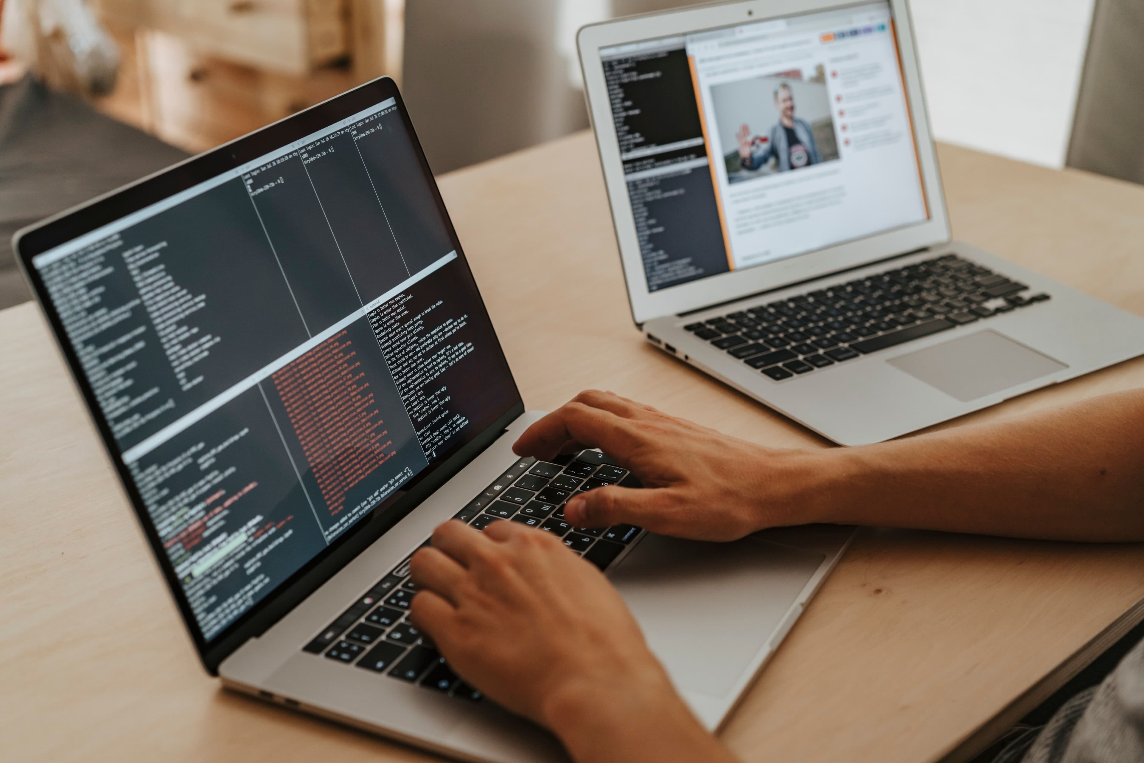 Stock photograph of website development with code displayed on laptops